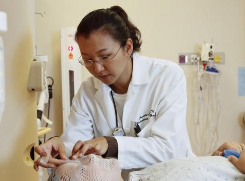 NHS Capacity. A radiation therapist fits a facemask for CT and radiation treatment.
