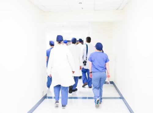 A group of healthcare workers walking through a hospital