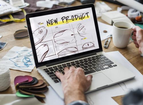 Laptop with skethches of a new product ,design and innovation