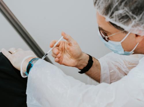 A man delivering a vaccine