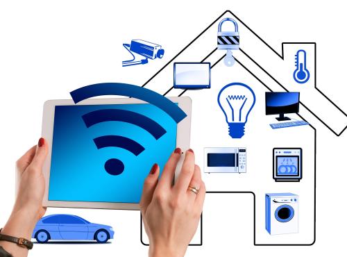 Picture of smart home being controlled by someone holding a tablet computer