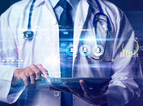 A doctor working on a digital device (Unsplash)