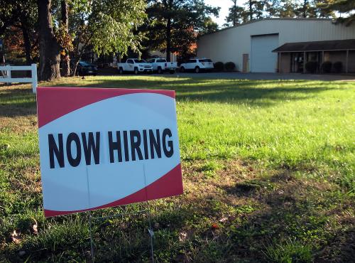 a sign saying "Now hiring"