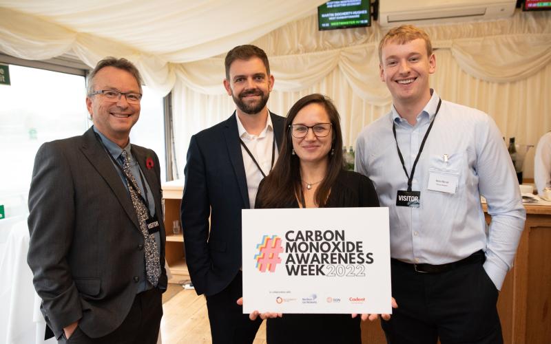 Attendees with sign for Carbon Monoxide Awareness Week 