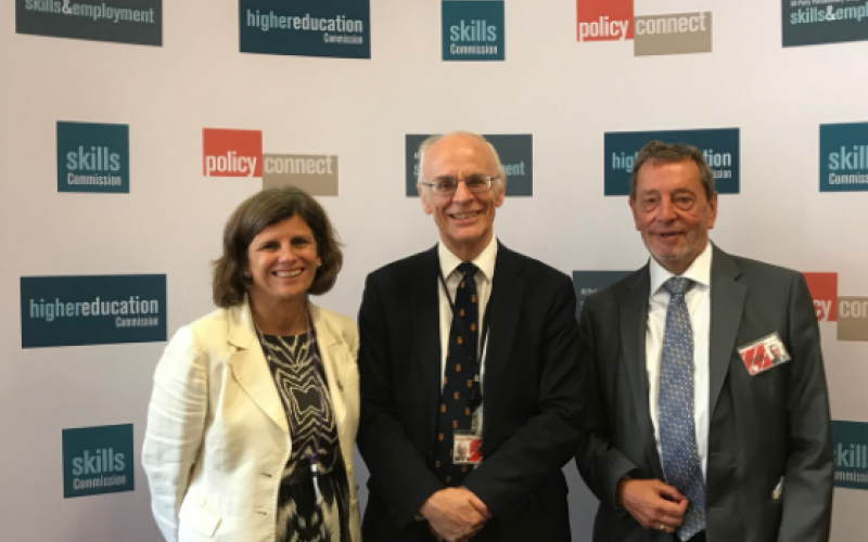 Kathryn Mitchell (VC University of Derby), Lord Norton and Lord Blunkett standing and smiling in front of the Policy Connect / HE Commission banner